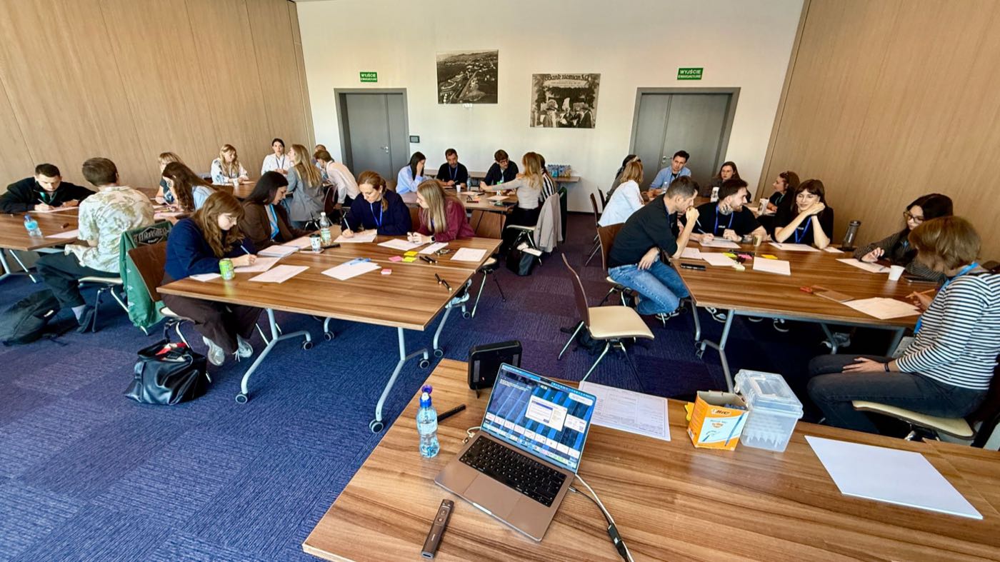 Participants working in pairs and small groups on the 3W Loop canvas during the WaysConf masterclass